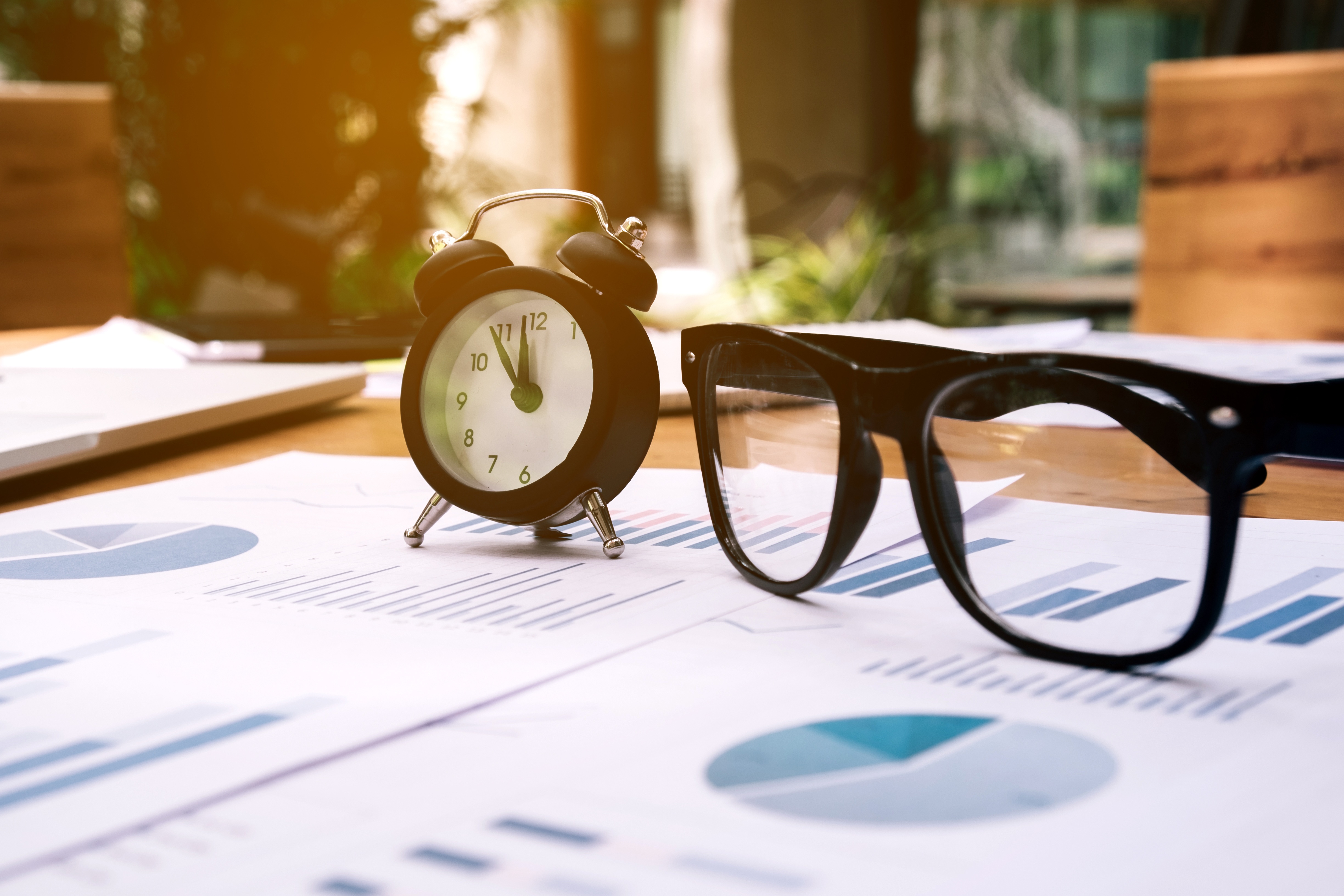 Glasses-and-clock-on-the-business-paper.-Report-chart-870388238_4896x3264